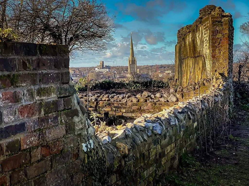 view of the cathedral through the ruins of St. Michael's church in Norwich