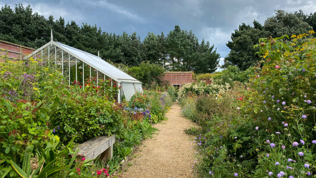 path by a greenhouse at the old vicarage garden