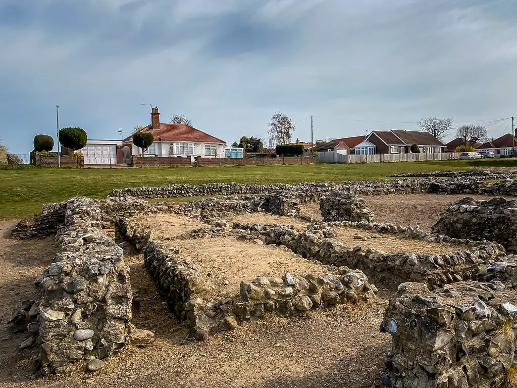 caister roman ruins with houses in the background