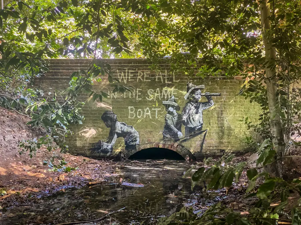 kids on boat in olton broad by banksy