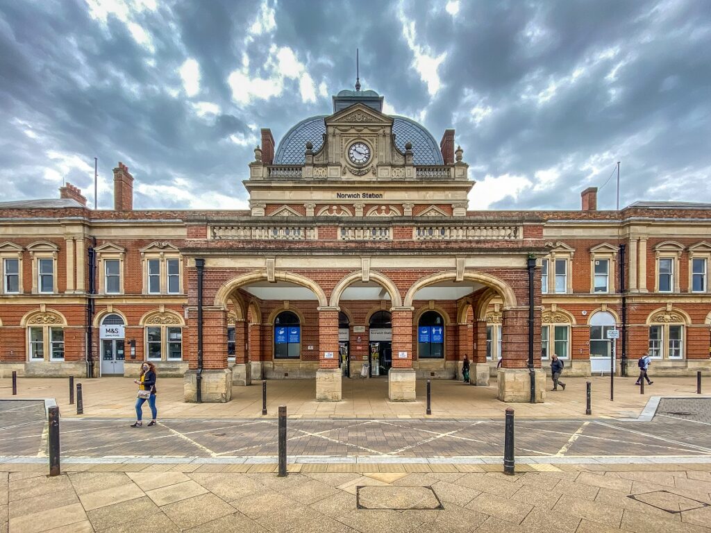 exterior of norwich train station with dramatic clouds