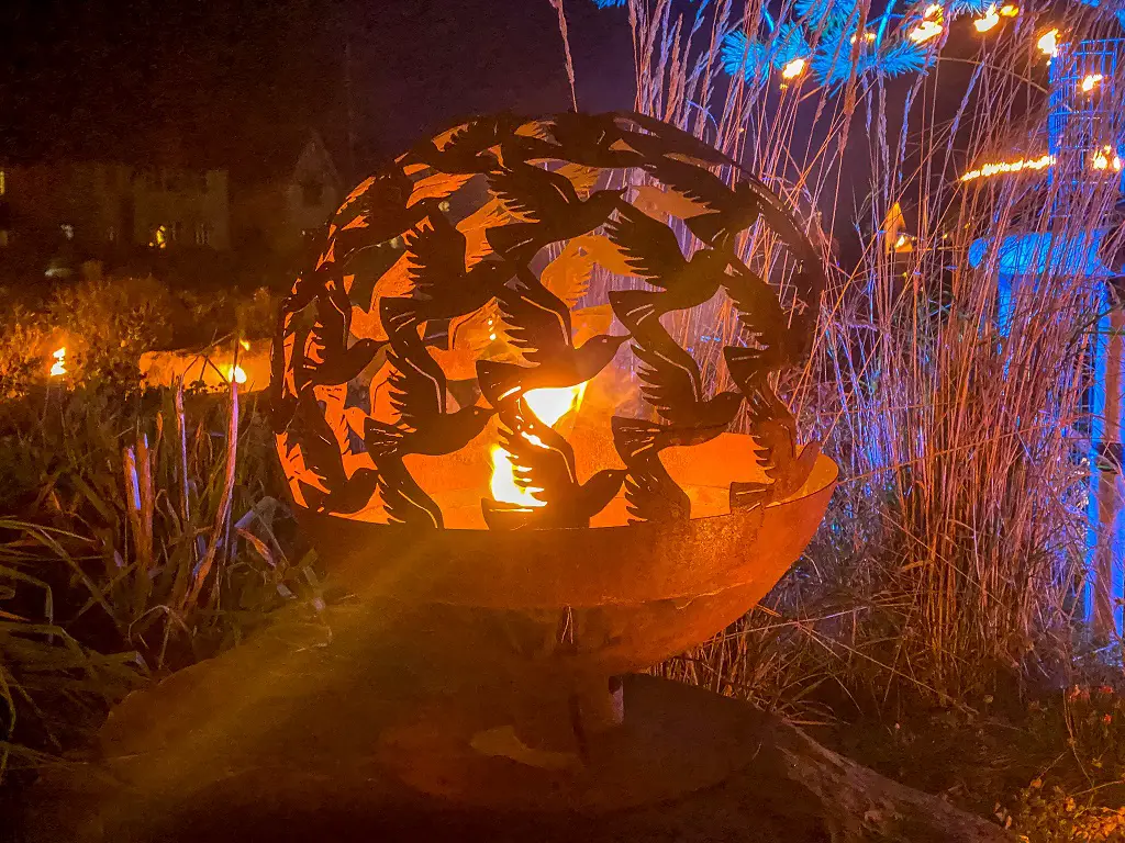 bird themed sculpture with fire inside