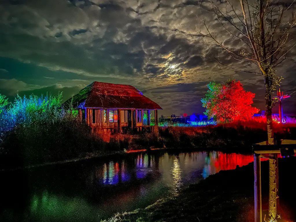 building inside the venetian waterways with colourful light displays around it at fire on the water