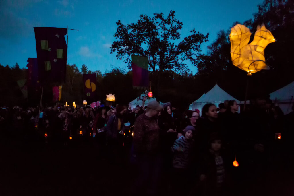 dark scene with people holding lanterns