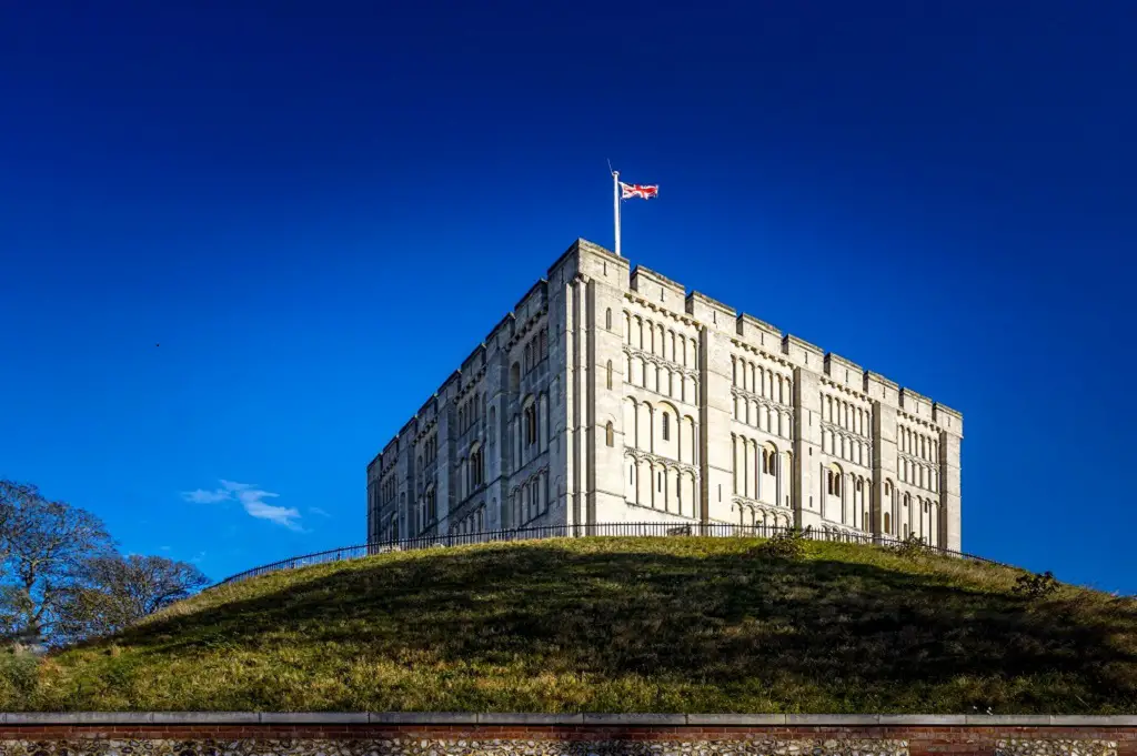 norwich castle with union jack flag flying in the wind
