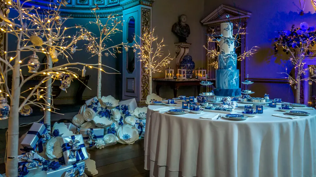 delft room at holkham hall decorated in blue and white, with a cake as centerpiece on the table