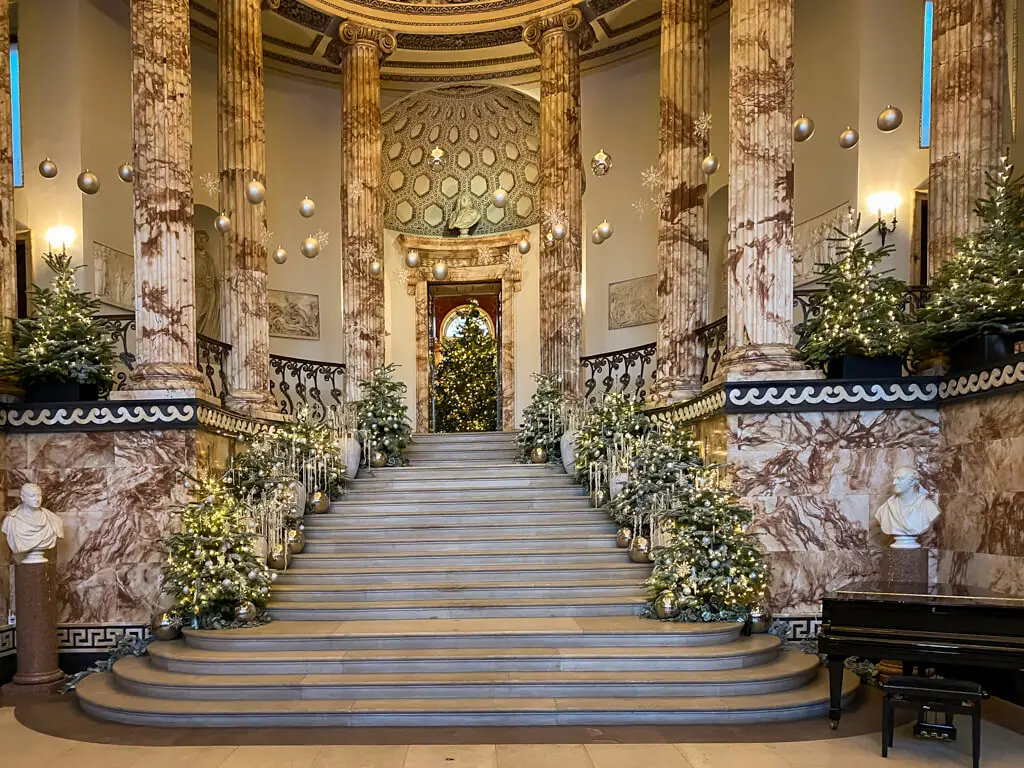 the grand staircase in the marble hall where you start your holkham hall by candlelight tour