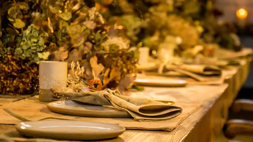 table setting with dried flowers in the old kitchen at Holkham Hall