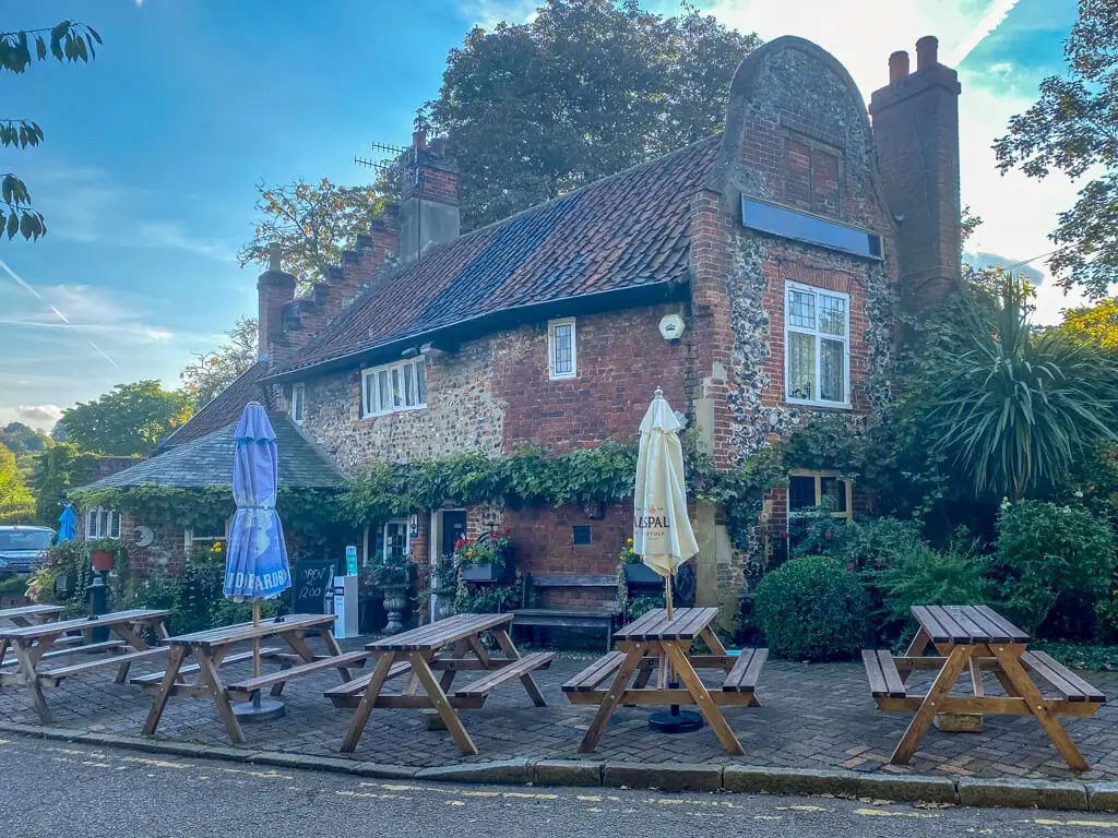 exterior view of the adam & eve pub with picnic tables outside