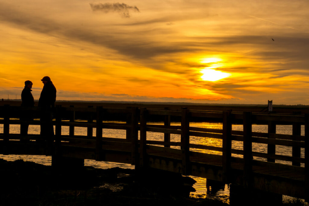 two people on the bridge close to Burgh Castle at sunset