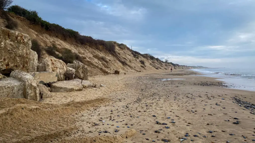 looking down Hemsby beach with cliffs on the left and sandy area filling most of the photo