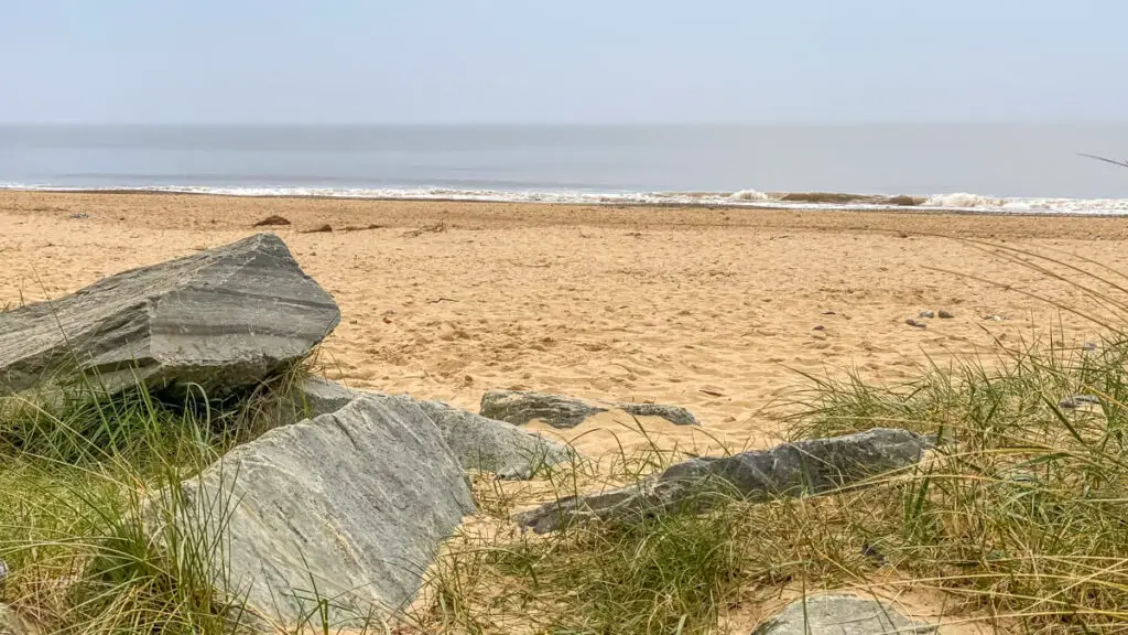 view of rocks and sand and sea at scratby beach near great yarmouth