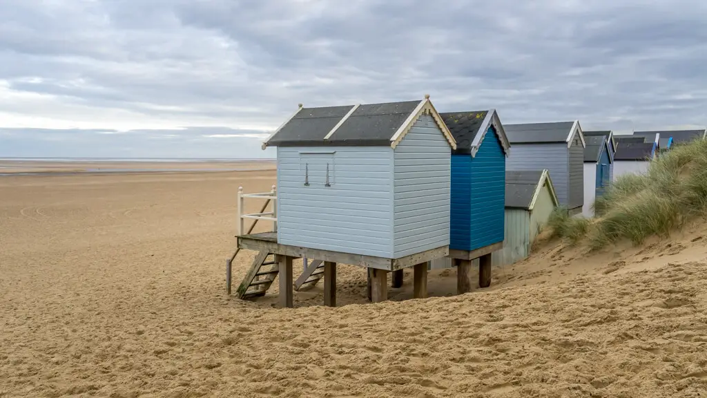 looking at wells beach from behind a few of the beach huts