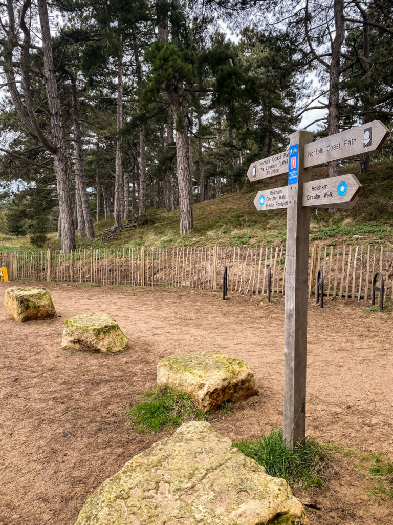 sign showing direction for walks in the area (including norfolk coast path)