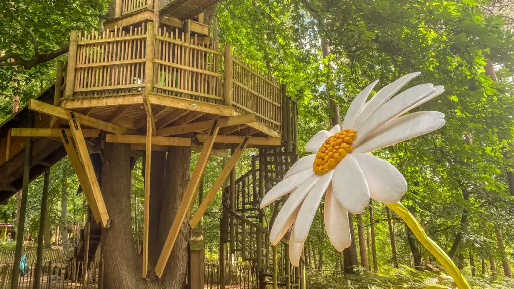 wooden playground equipment and giant plastic flower