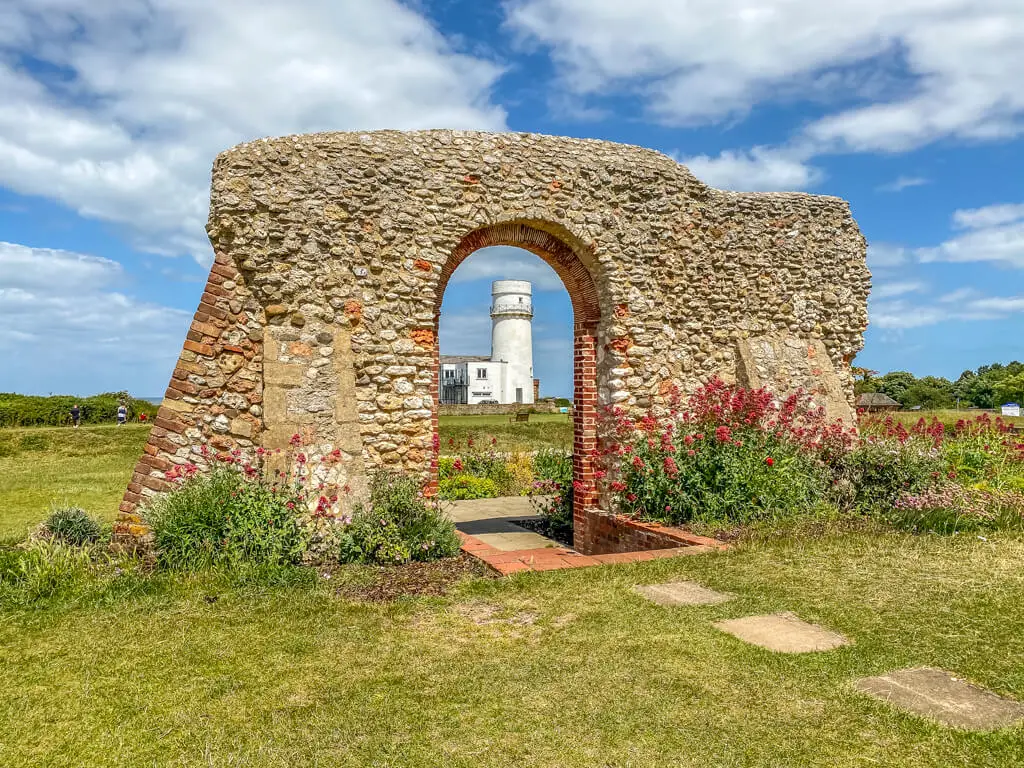 view of the hunstanton lighthouse through the arch of the ruins of St. Edmunds Chapel