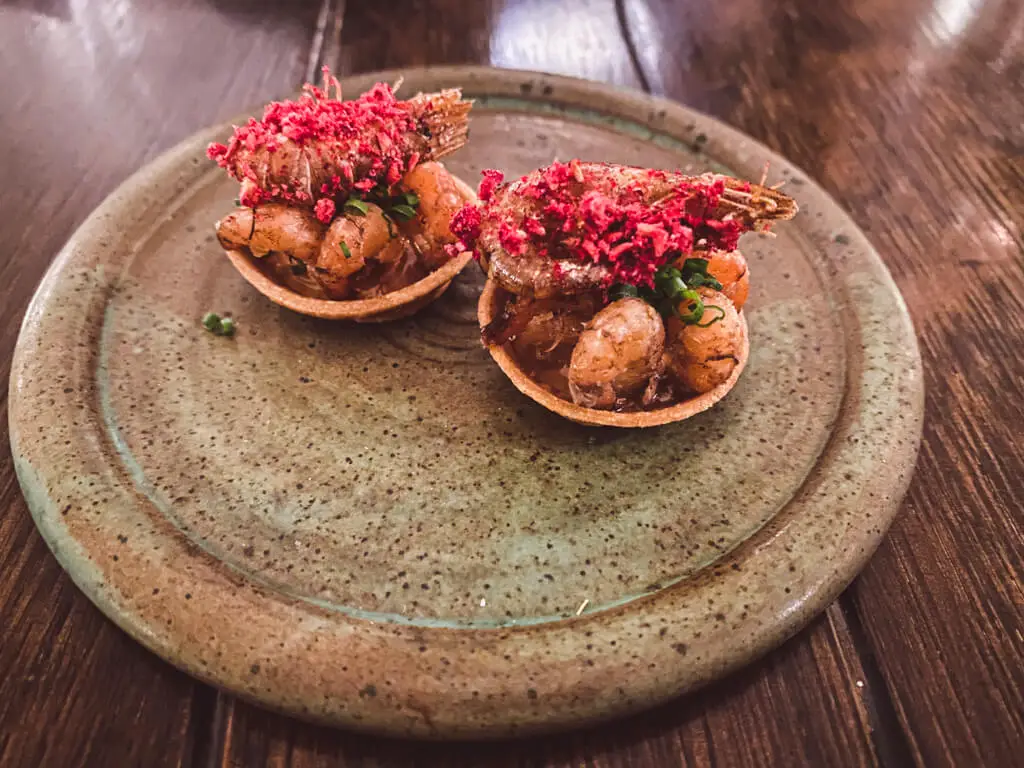 close up of two brown shrimp tartlets