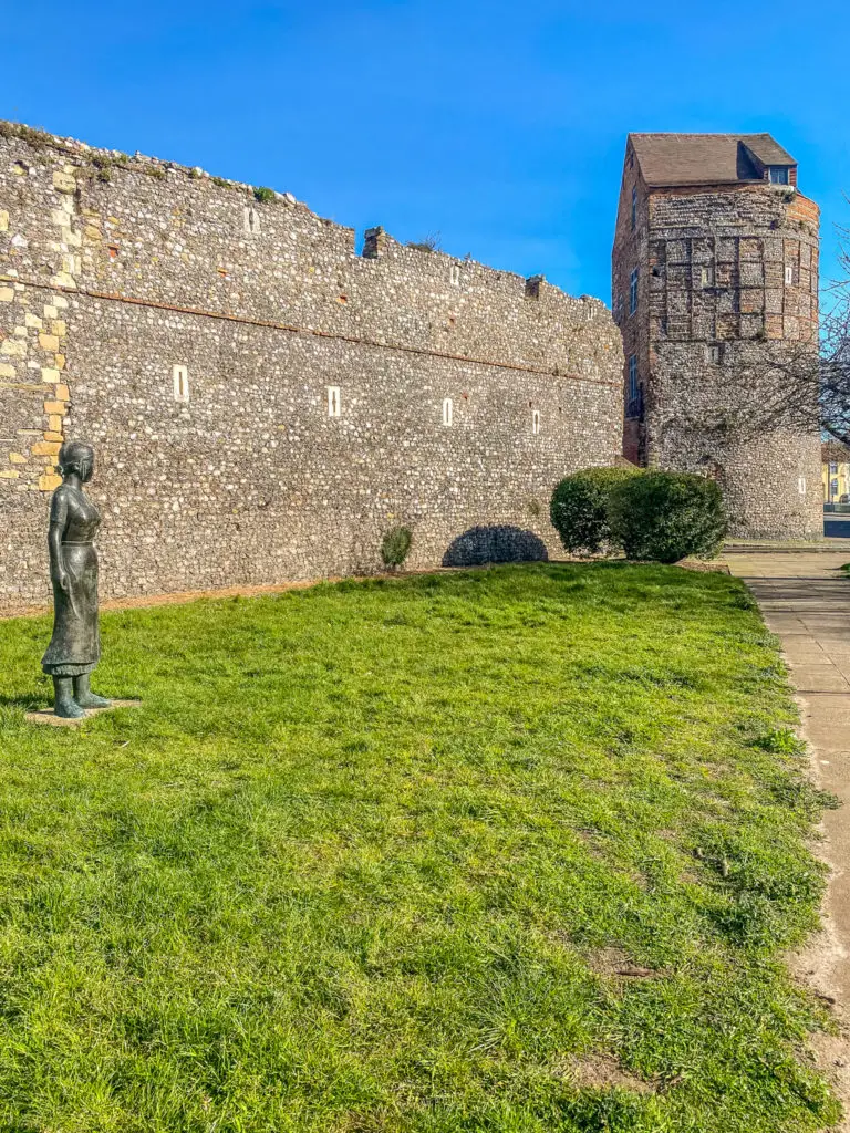 great yarmouth town walls with a sculpture of a woman in front of it