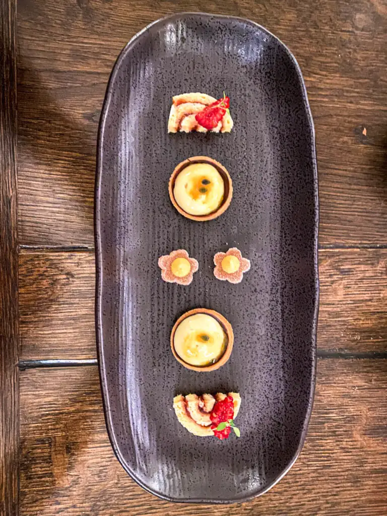 selection of petit fours on a black tray