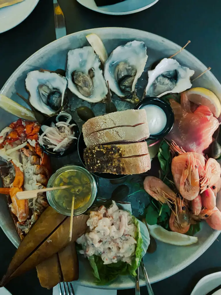 seafood platter - lobster, fish, shrimp, cockles, oysters, bread, lemon