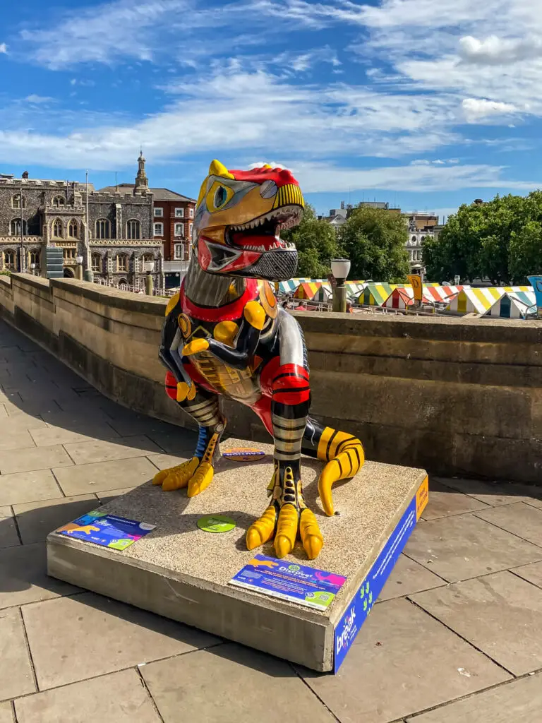 Automotive themed t-rex with norwich market in the background