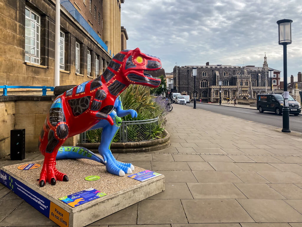 blue and red t-rex in front of norwich city hall