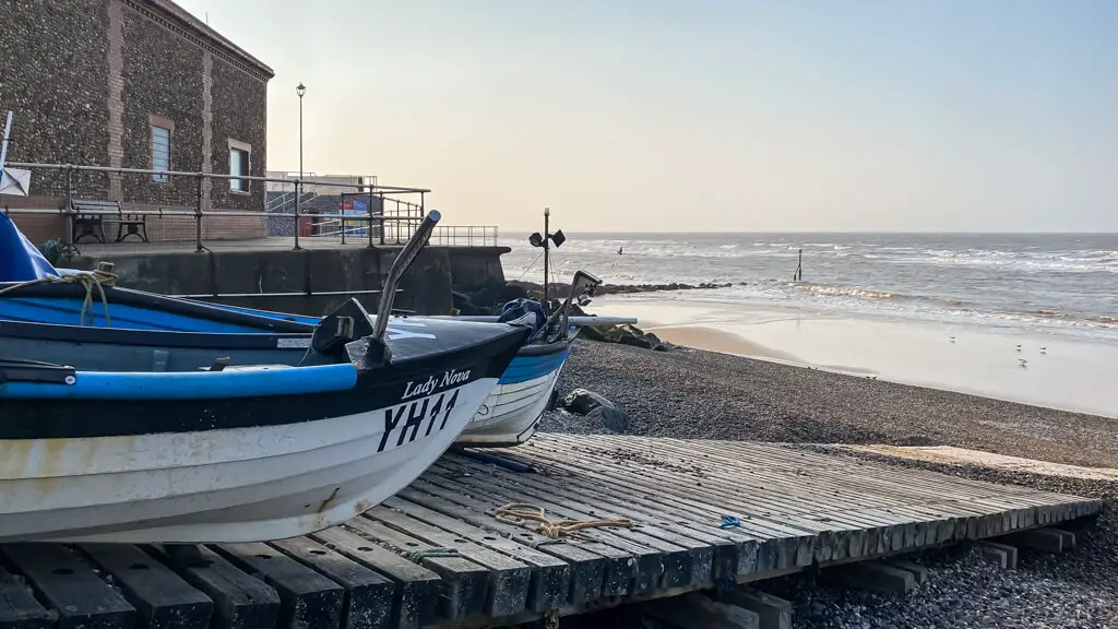 old boats and a view of Sheringham beach