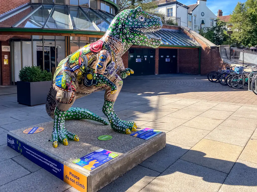 colourful t-rex in front of castle quarter entrance