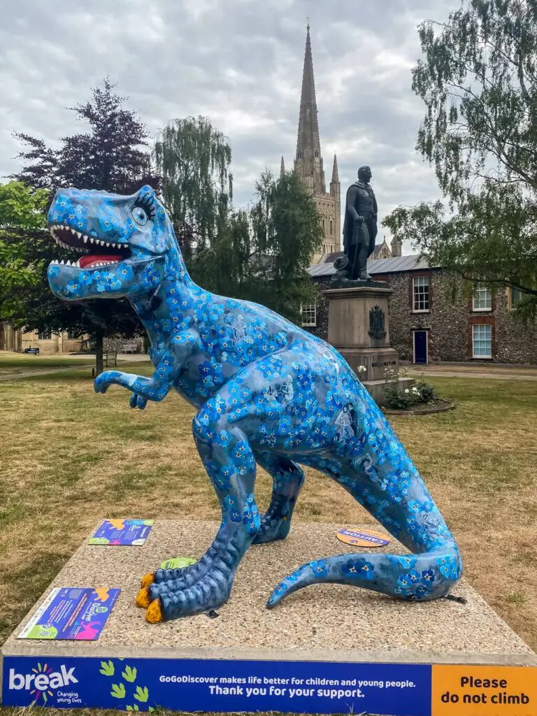 t-rex painted with blue forget me not flowers