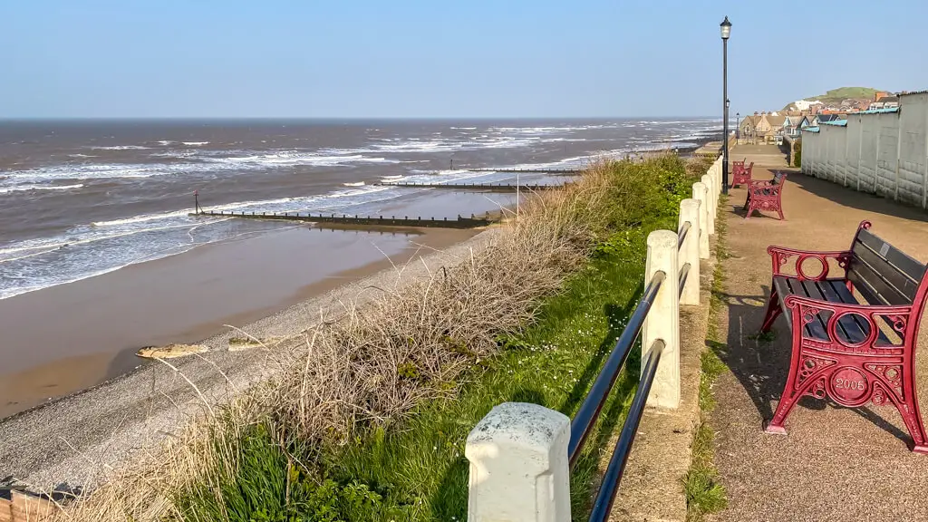 view from the cliffs in sheringham with a bench in the shot