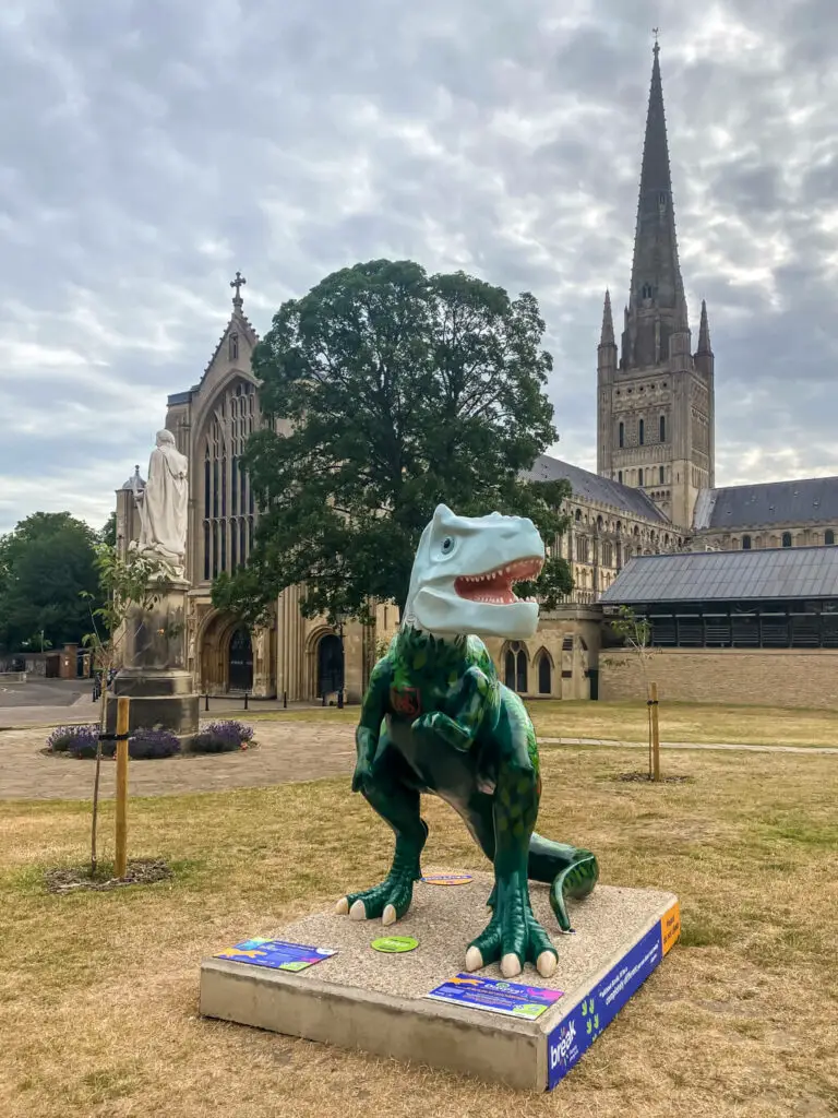 tyra-norvy saurus with the norwich cathedral in the background