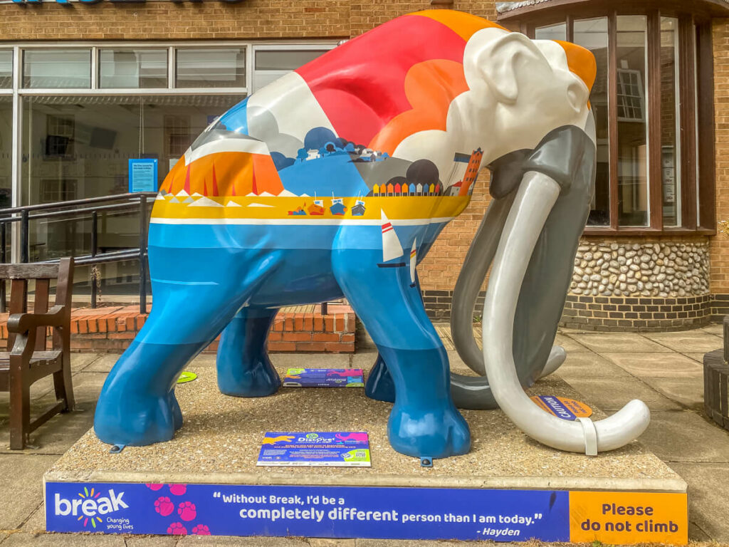 boldly coloured mammoth with scenes of the north norfolk coast painted on the middle