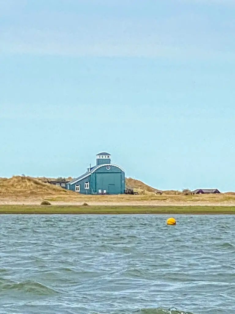 blakeney lifeboat house, uniquely shaped green building on the beach