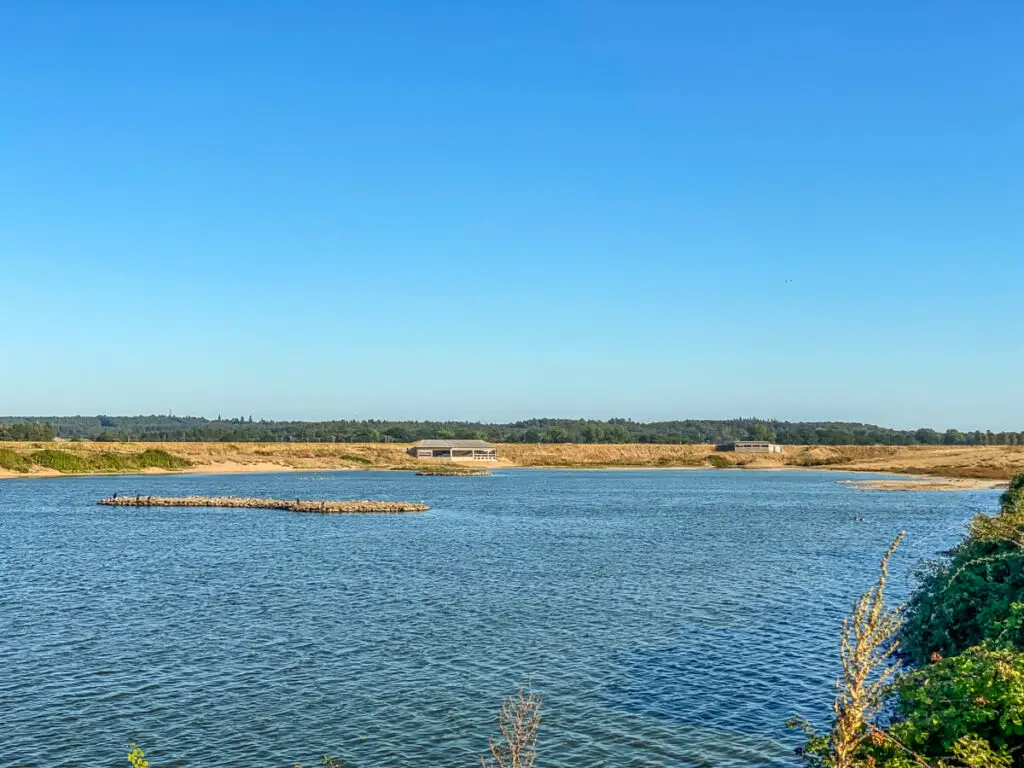 looking over the lagoon to two bird hides in the distance