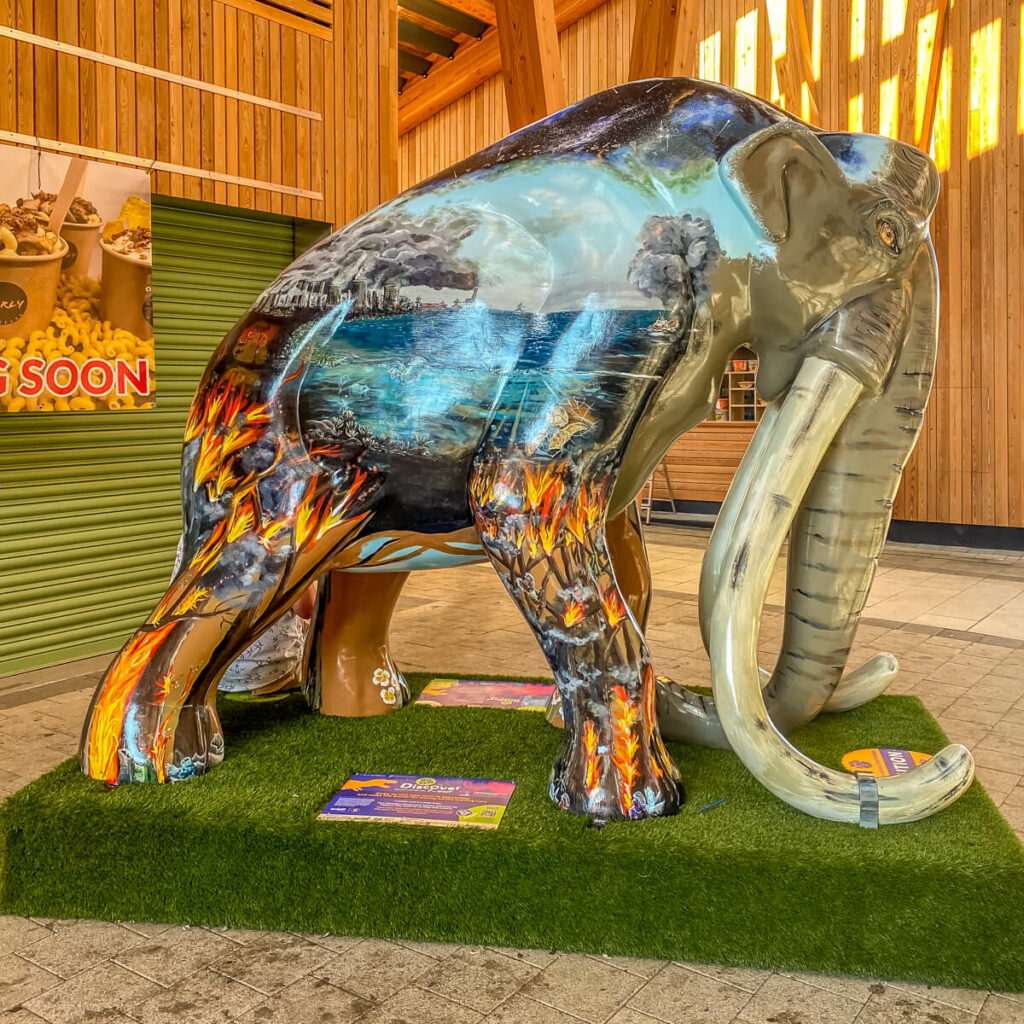 mammoth sculpture with fire painted on its legs