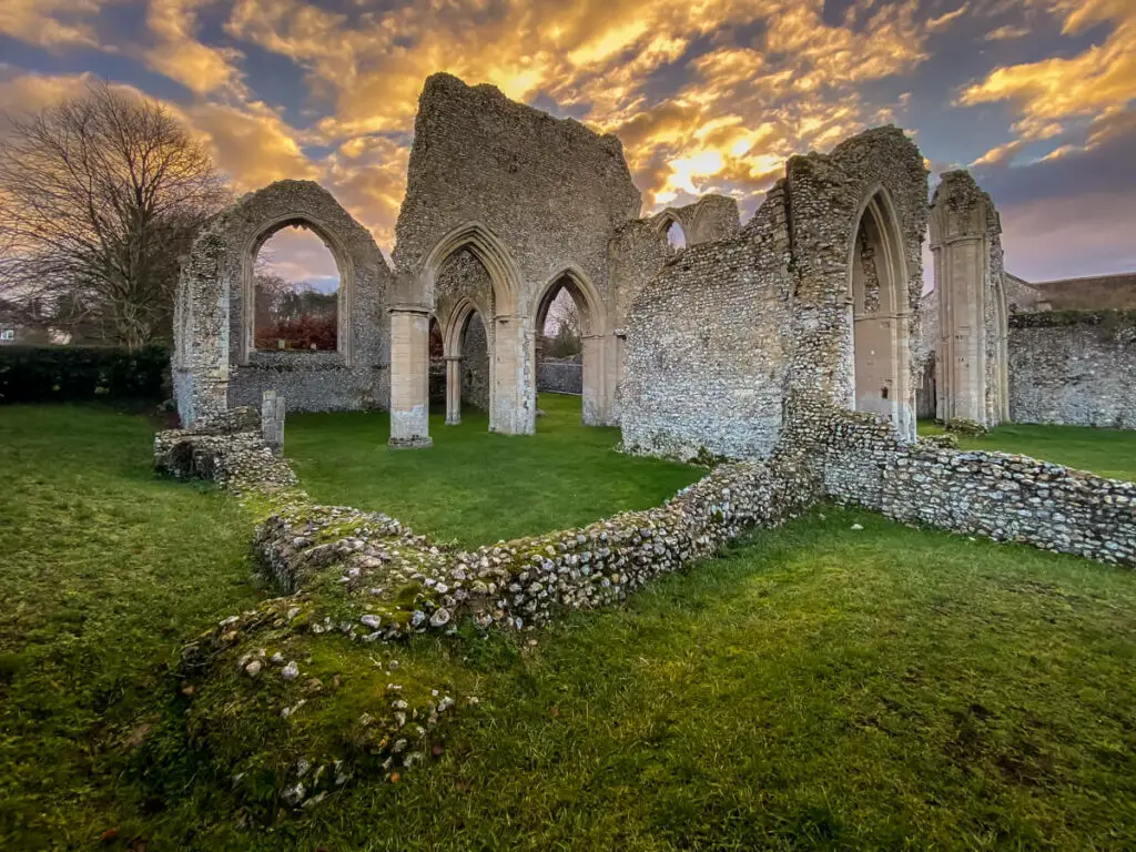 view of the main section of creake abbey ruins with a dramatic sky