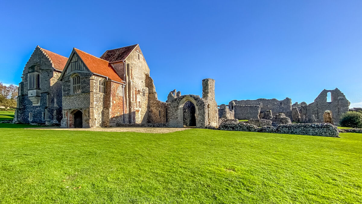 a view of the main building and castle acre priory ruins, one of the best english heritage sites to visit in Norfolk