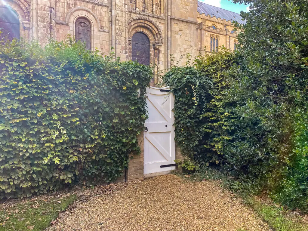 white gate that leads to Norwich Cathedral from the bishops garden