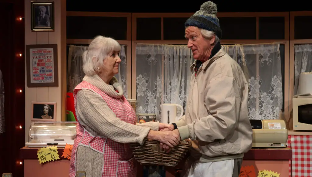 may and ken holding the basket of bread togething in the cafe