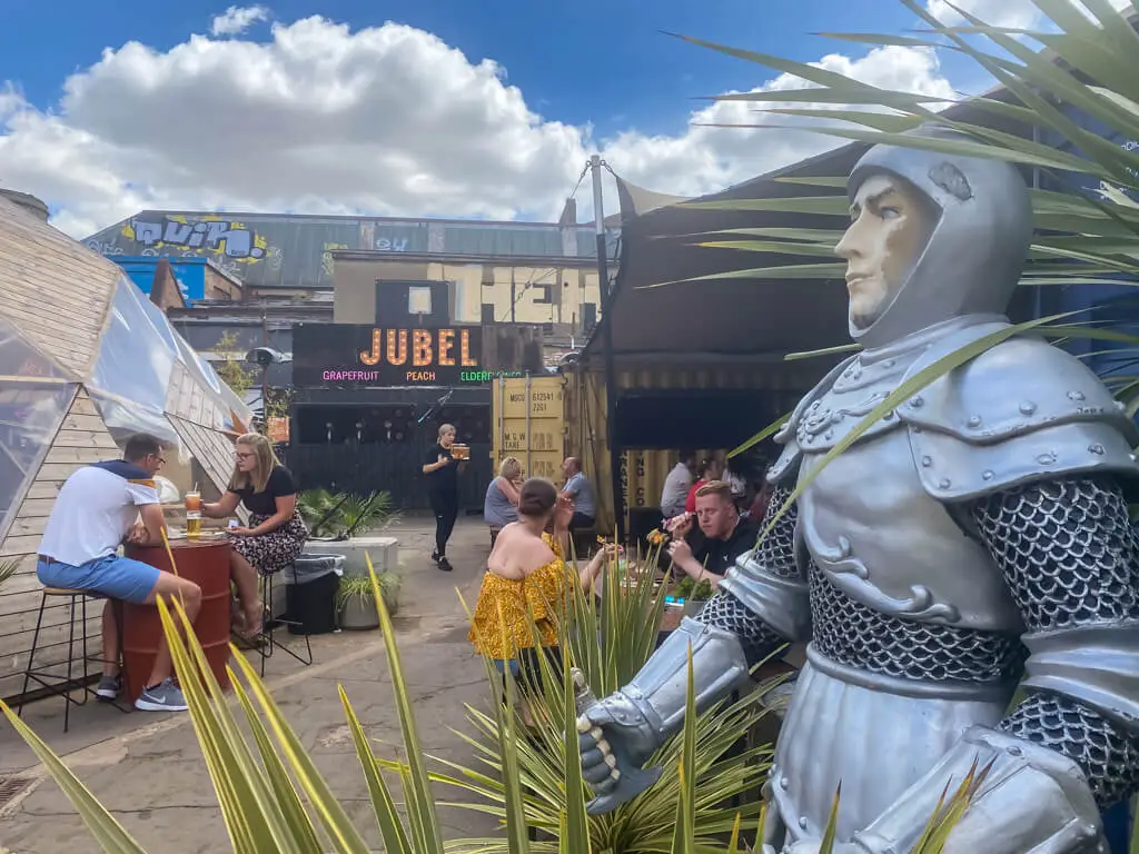 knight in armour by seating area at junkyard market