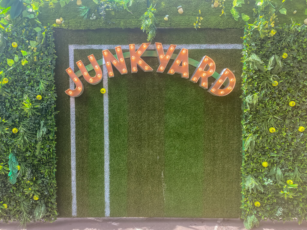 "junkyard" in lights against a green background