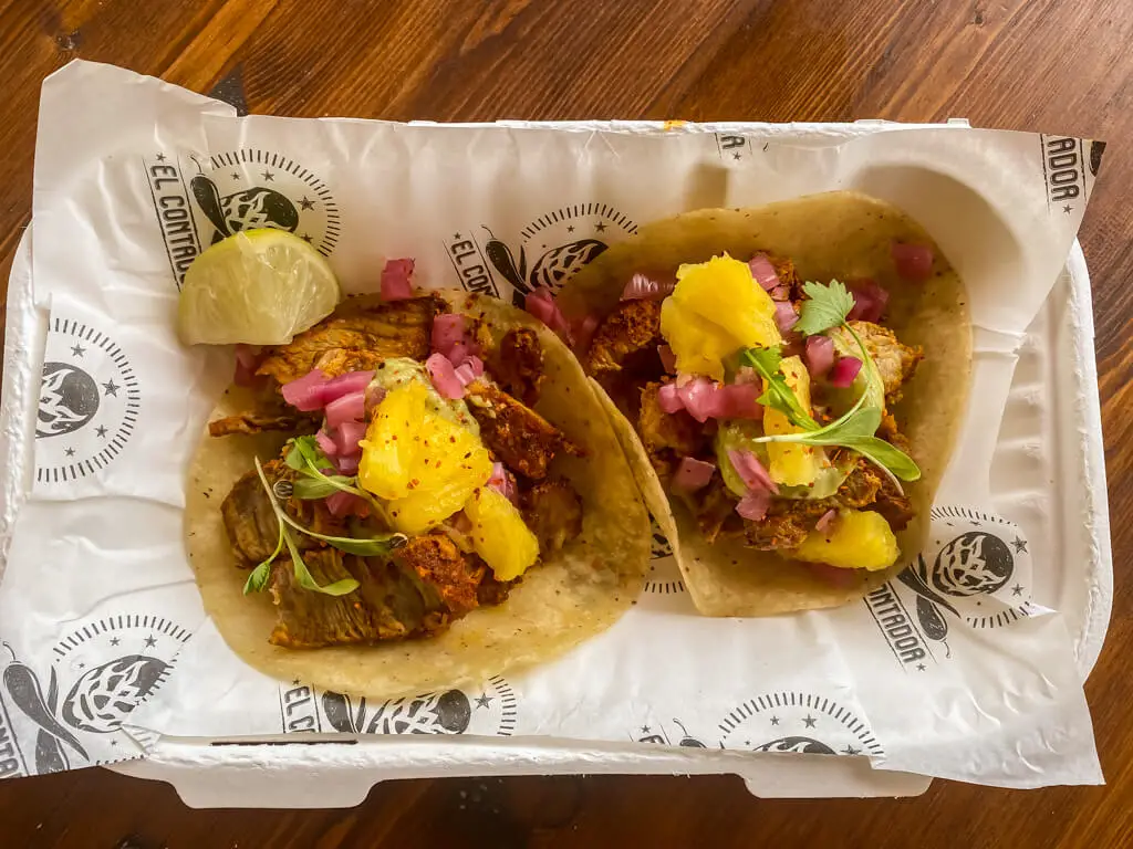 aerial view of two tacos with a slice of lime