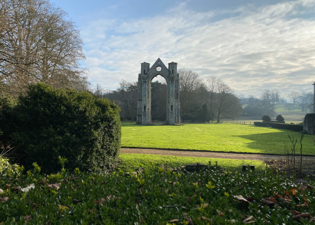 view of walsingham abbey east window arch from a distance