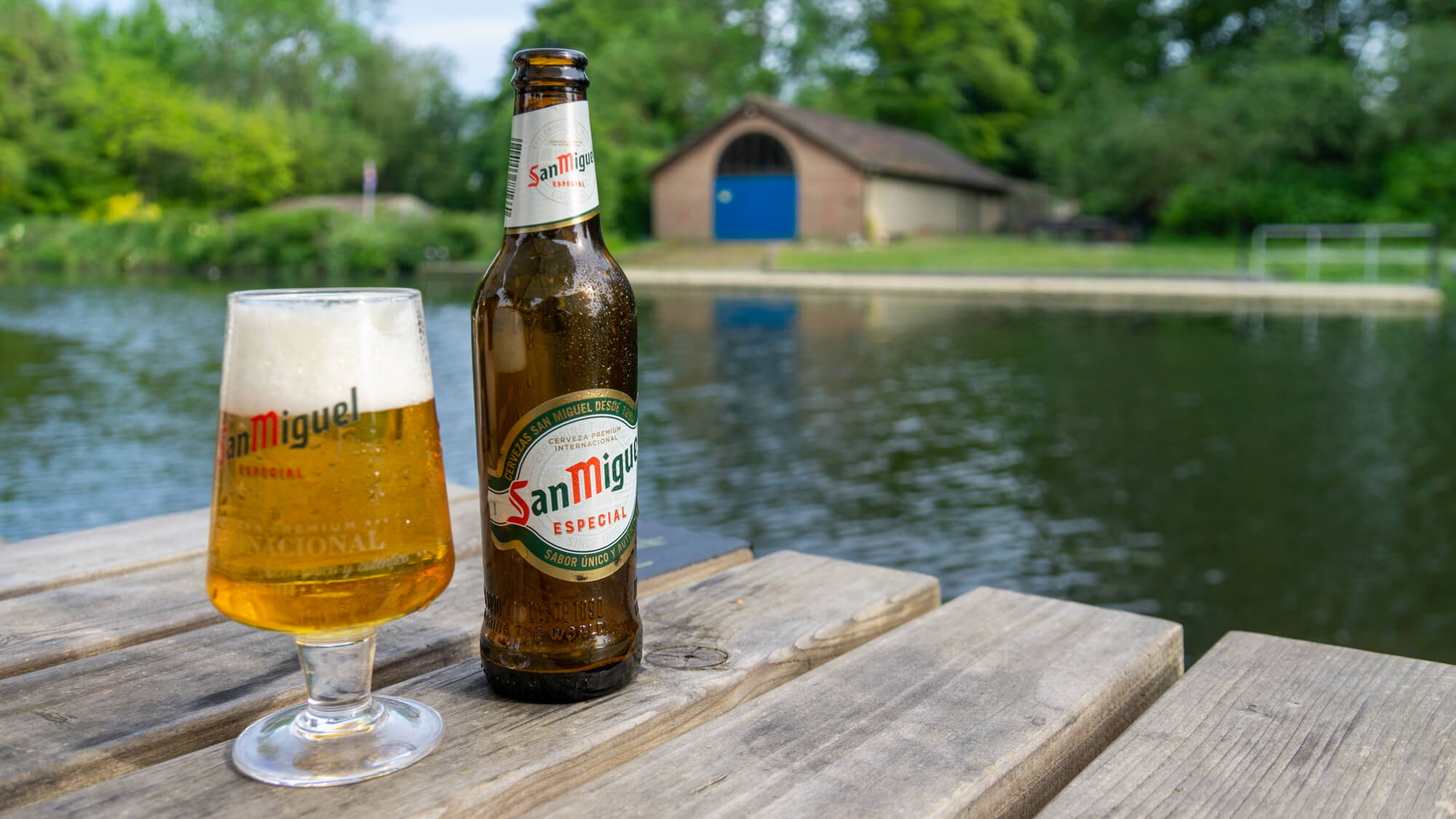 bottle of san miguel beer with glass on table at the Rivergarden, a riverside pub by the river yare just outside norwich city centre