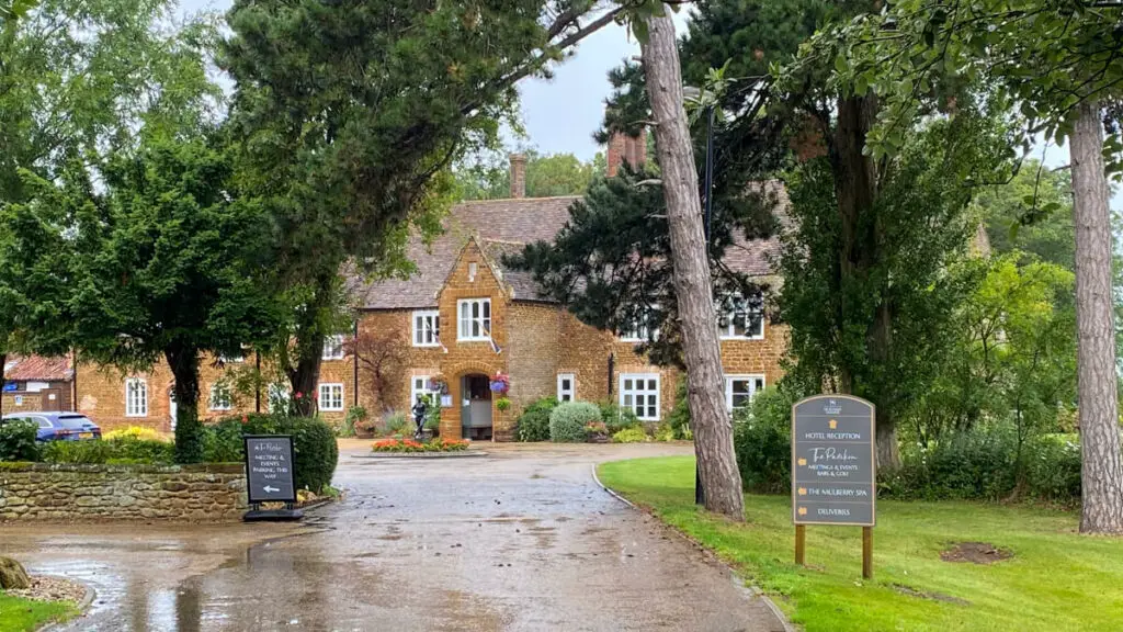 exterior view of Heacham Manor through the trees