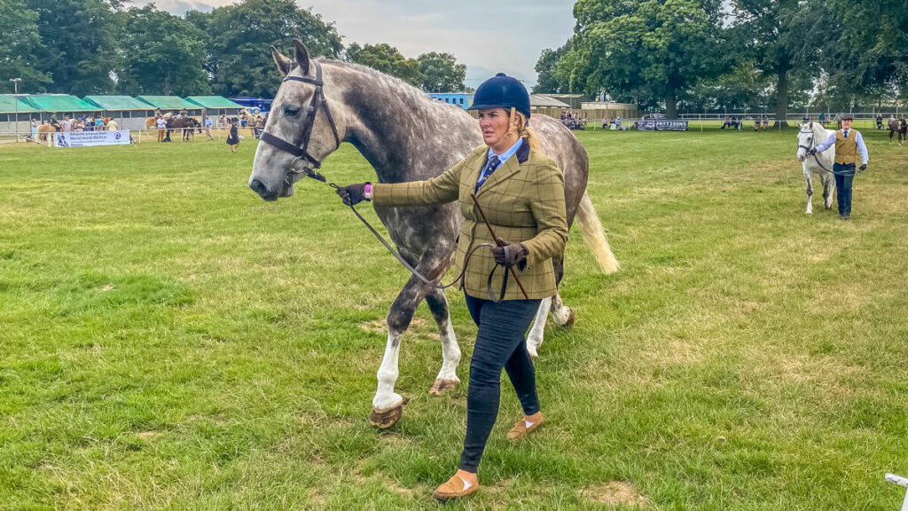 lady standing next to her horse at the royal norfolk show