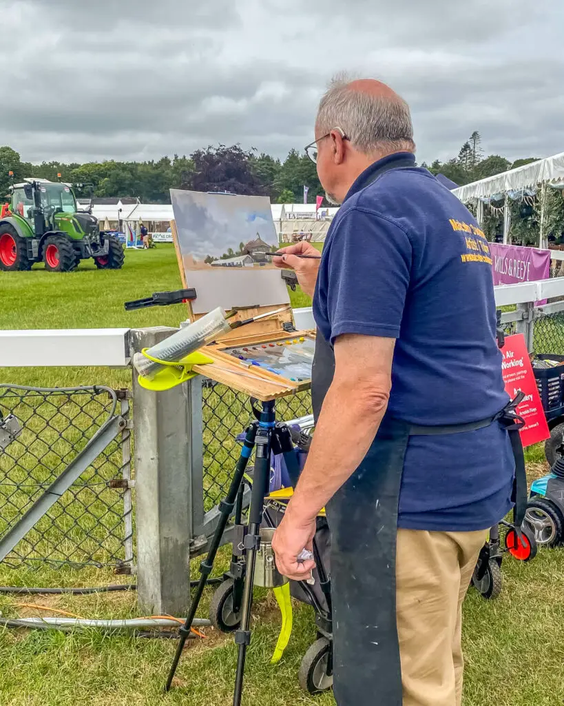 artist paints the grand ring at the Royal Norfolk Show