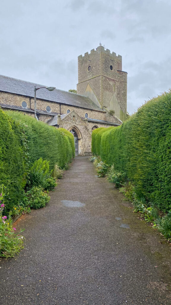 view looking down the path toward the tower of St. Mary's Church in Heacham