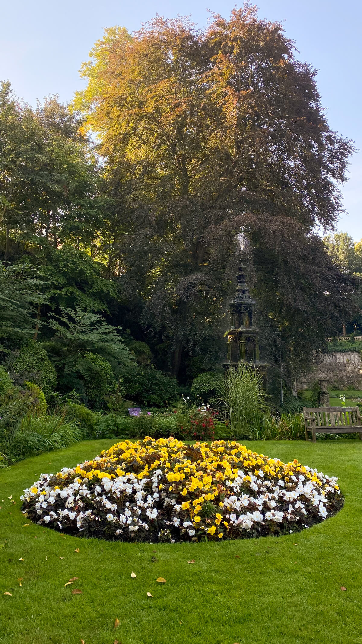 flower bed with trees behind it at the Plantation Garden Norwich.