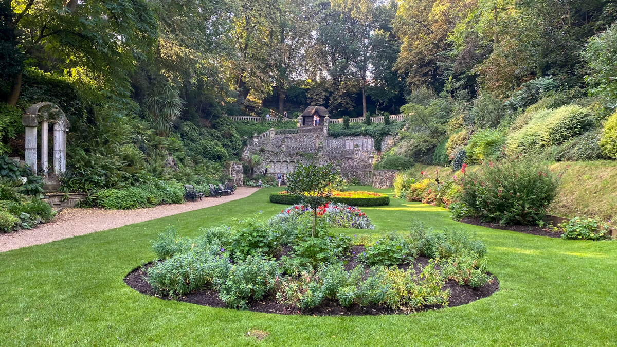 view of the plantation garden in norwich looking over the main lawn with flower beds towards the Italian Terrace